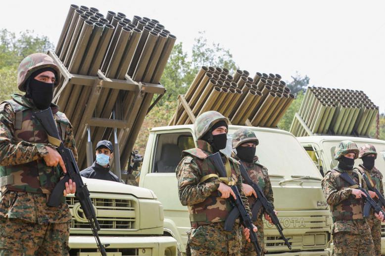 Hezbollah members take part in a military exercise during a media tour in May