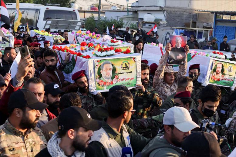 Mourners carry the coffins of Iraq's Kataib Hezbollah fighters who were killed by US airstrike