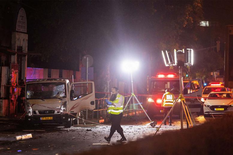 Israeli security and emergency responders work at the site of a bomb blast in Tel Aviv