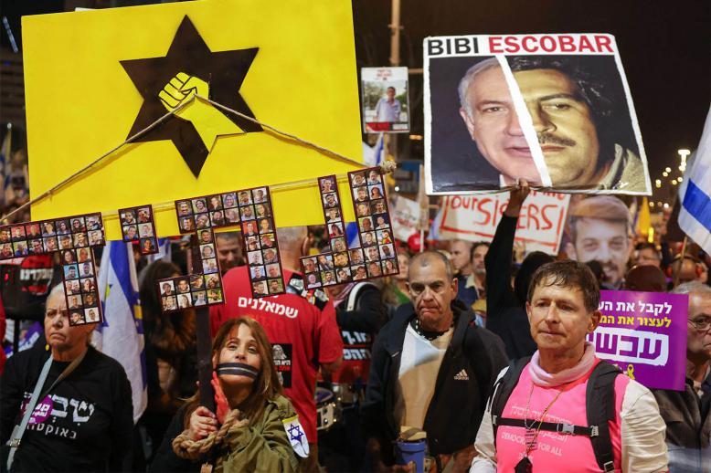  Protesters hold placards and wave flags during a demonstration calling for the release of hostages held captive in Gaza 