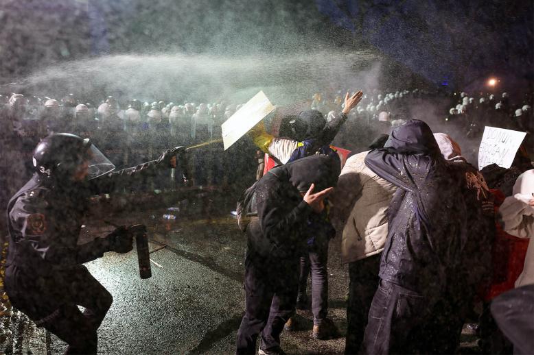 Police officers use pepper spray on demonstrators during a protest against the detention of Istanbul Mayor Ekrem Imamoglu