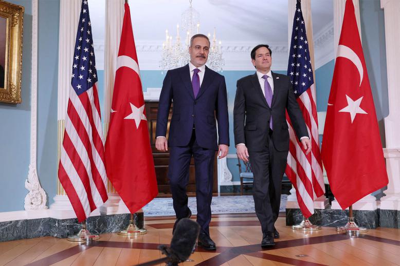 US Secretary of State Marco Rubio walks into the room with Turkish Foreign Minister Hakan Fidan at the State Department in Washington