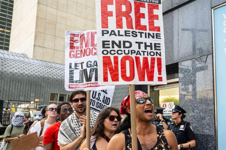 People participate in a protest in support of Palestine outside the UN as a conference on Palestine and a two-state solution takes place inside the UN 