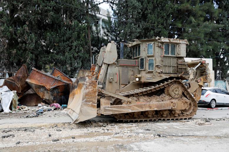 An armored caterpillar bulldozer stands on a street during an Israeli raid at Tulkarm