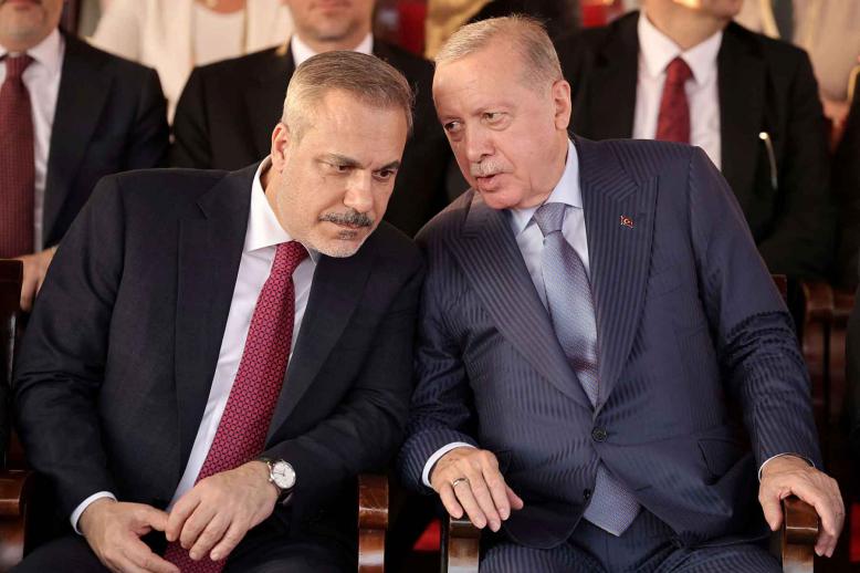 Turkish President Recep Tayyip Erdogan and Turkish Foreign Minister Hakan Fidan attend a military parade in the Turkish-controlled northern Cyprus, in the divided city of Nicosia, July 20, 2025. 