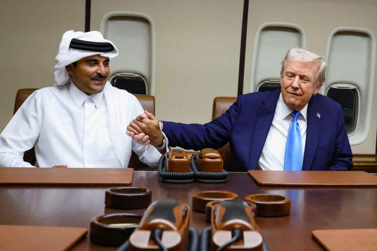 US President Donald Trump shakes hands with Qatar’s Emir Sheikh Tamim bin Hamad Al Thani during a meeting onboard Air Force One during its refuelling stop at Al Udeid Air Base near Doha, October 25, 2025. 