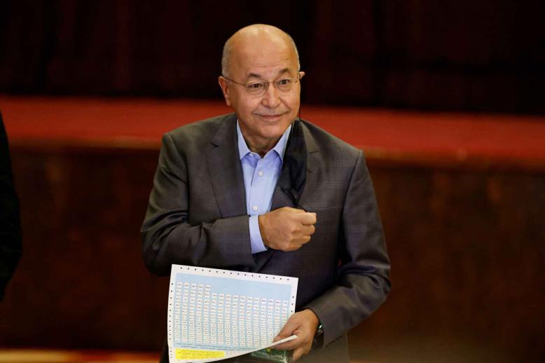 Iraq’s former president Barham Salih casts his vote at a polling station in Baghdad, as Iraqis go to the polls to vote in the parliamentary election, October 10, 2021. 