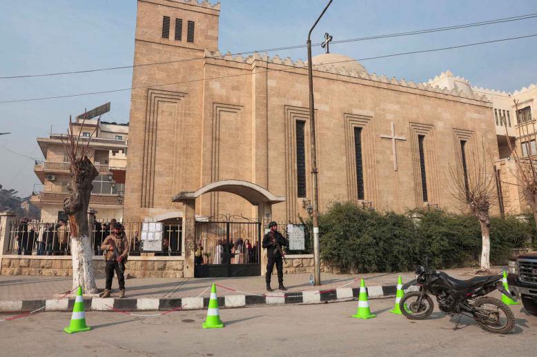 Members of the security forces stand in front of the St. Joseph Chaldean Cathedral on the day Christians attend Christmas Mass celebrations at the Chaldean Catholic Church, in Aleppo, Syria, December 25, 2025. 