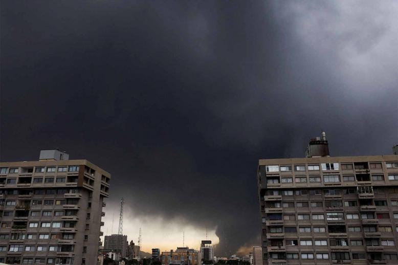 Smoke rises after a reported strike on fuel tanks at an oil refinery in Tehran