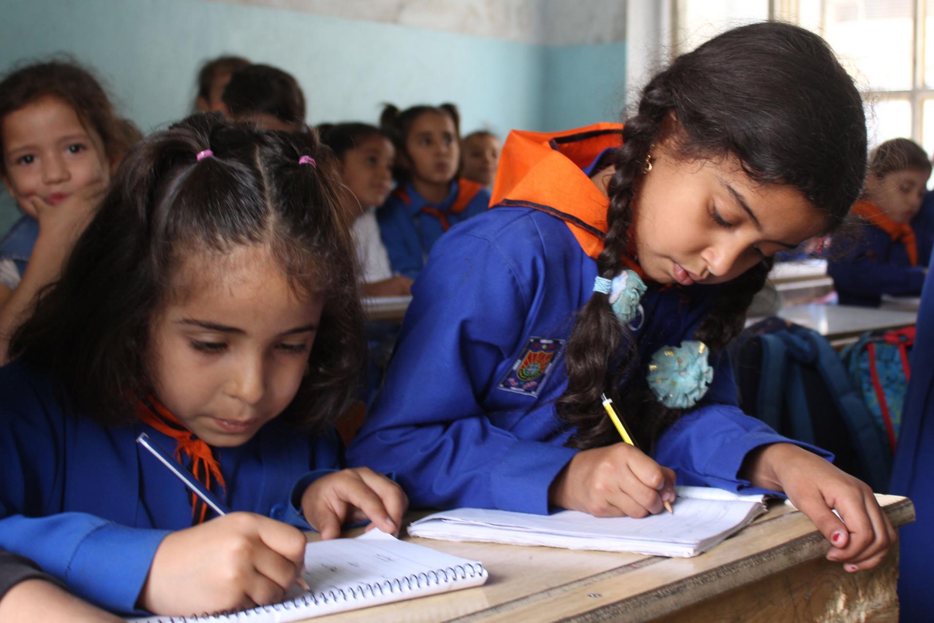Syrian students attend classes at a school run by the Syrian government in the northeastern multi-ethnic city of Hassakeh on October 10, 2018. 