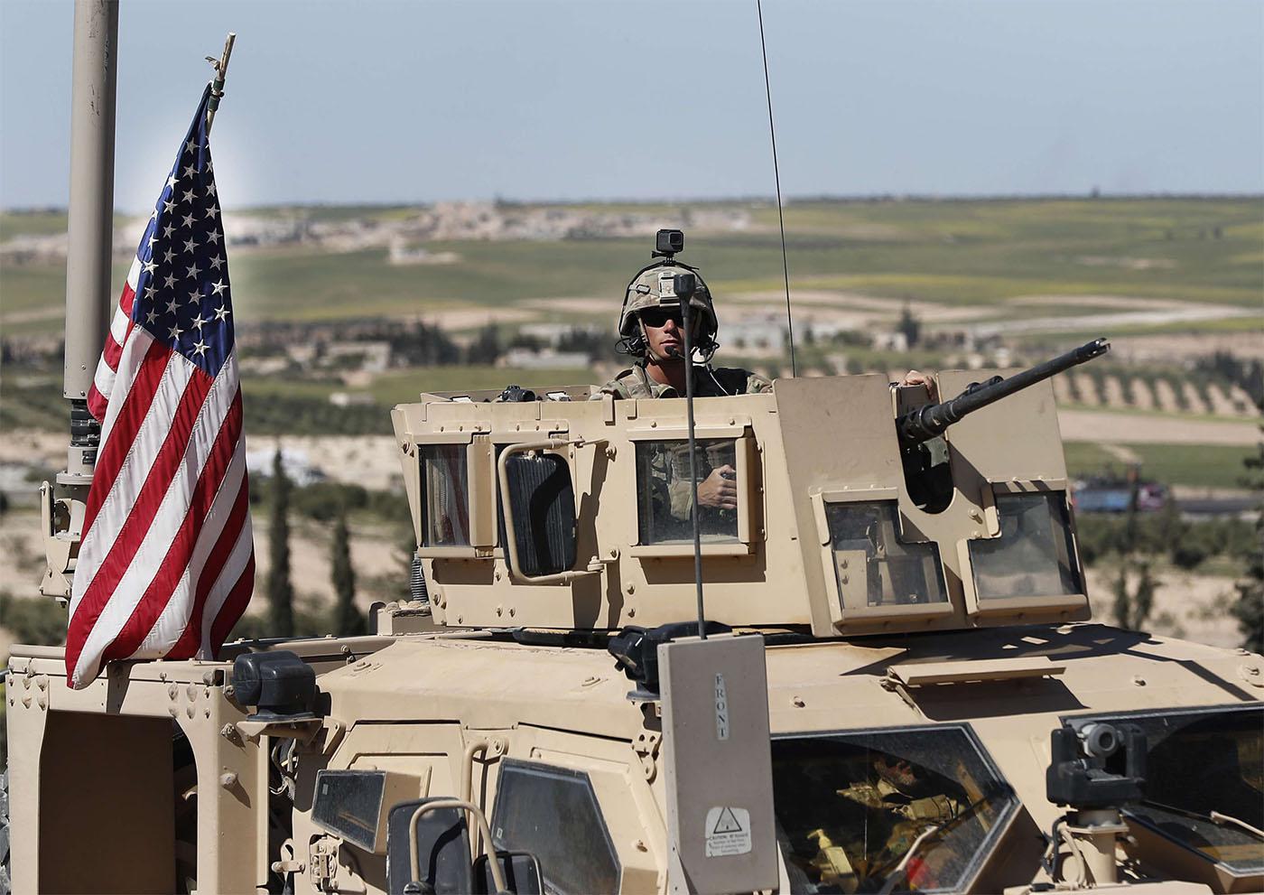 US soldier sits in an armored vehicle