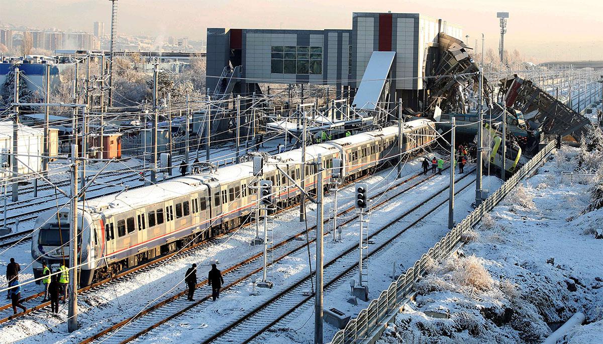 Rescue workers search at the wreckage after a high speed train crash in Ankara