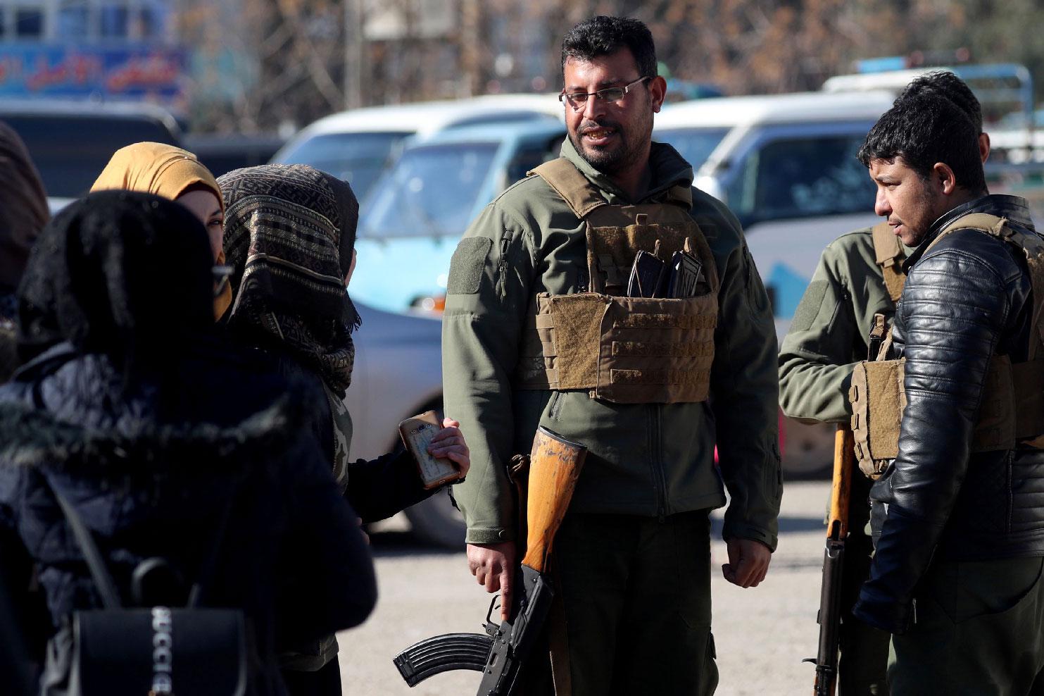 Armed men stand guard the streets in the northern Syrian town of Manbij, controlled by Kurdish-dominated Syrian Democratic Forces (SDF), on December 29, 2018.