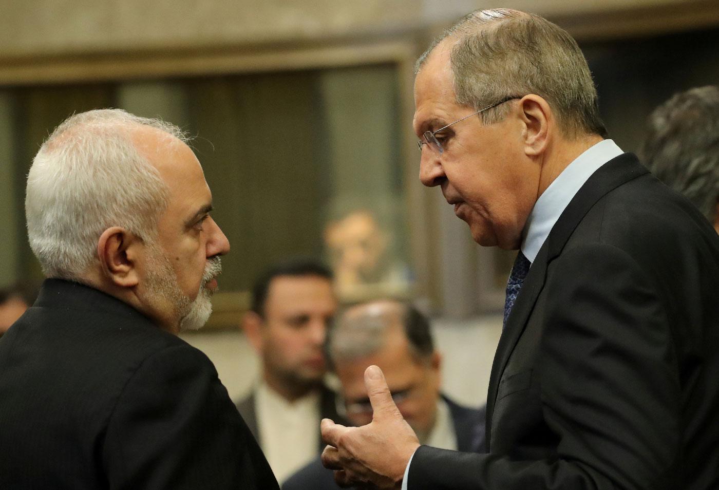Russian Foreign Minister Sergei Lavrov and Iranian Foreign Minister Mohammad Javad Zarif are seen before a news conference after talks on forming a constitutional committee in Syria, at the United Nations in Geneva, Switzerland, December 18, 2018.