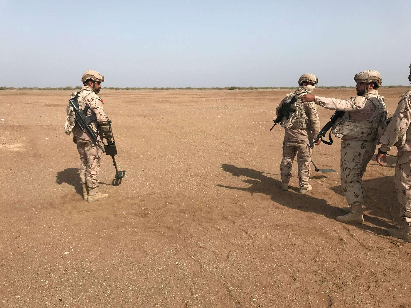 Members of the UAE armed forces secure an area while searching for landmines in Al-Mokha, Yemen March 6, 2018.