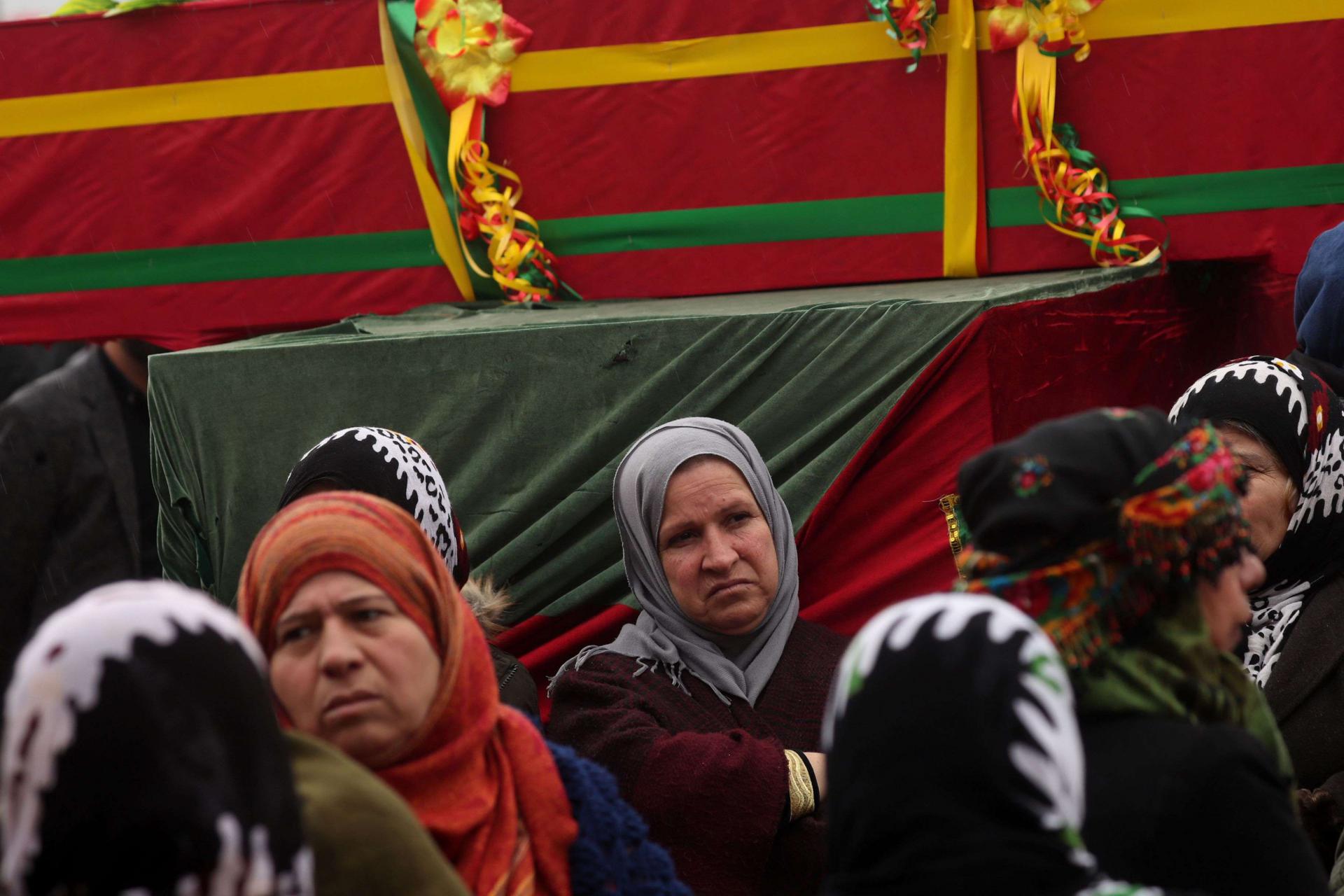Mourners surround the coffin of a local official, who fighters from the Syrian Democratic Forces (SDF) say was assassinated in a Kurdish-held area in the countryside of Deir Ezzor, during his funeral in northeastern Syrian Kurdish-majority city of Qamishli, on December 31, 2018.