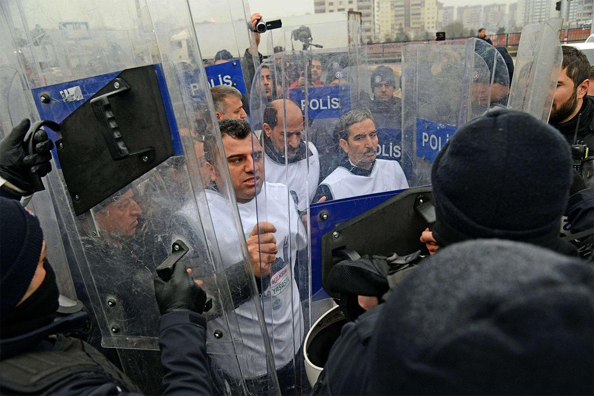 Turkish anti-riot police surround and block members of the pro-Kurdish Peoples' Democratic Party (HDP) during the demonstration