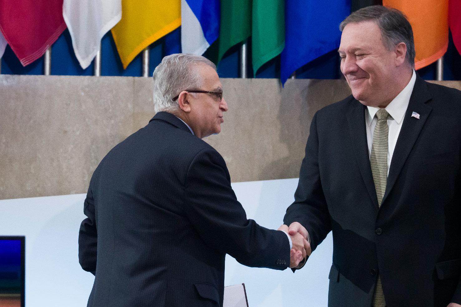 Iraqi Foreign Minister Mohamed al-Hakim, shakes hands with Secretary of State Mike Pompeo before al-Hakim speaks during the Global Coalition to Defeat ISIS meeting, at the State Department, Wednesday, Feb. 6, 2019, in Washington.