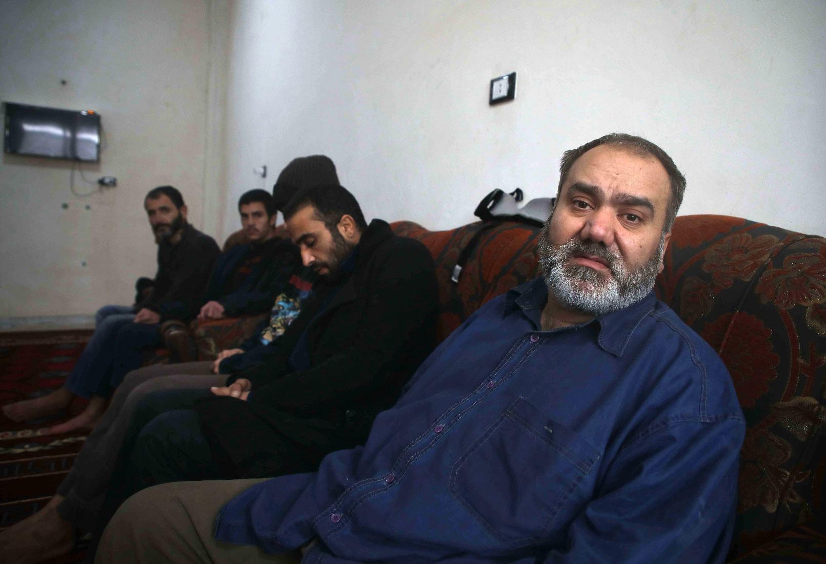 Syrian men suffering from mental issues sit together at al-Waalan special needs centre in northern town of Aldana near Syria's second largest city of Aleppo on February 14, 2019.