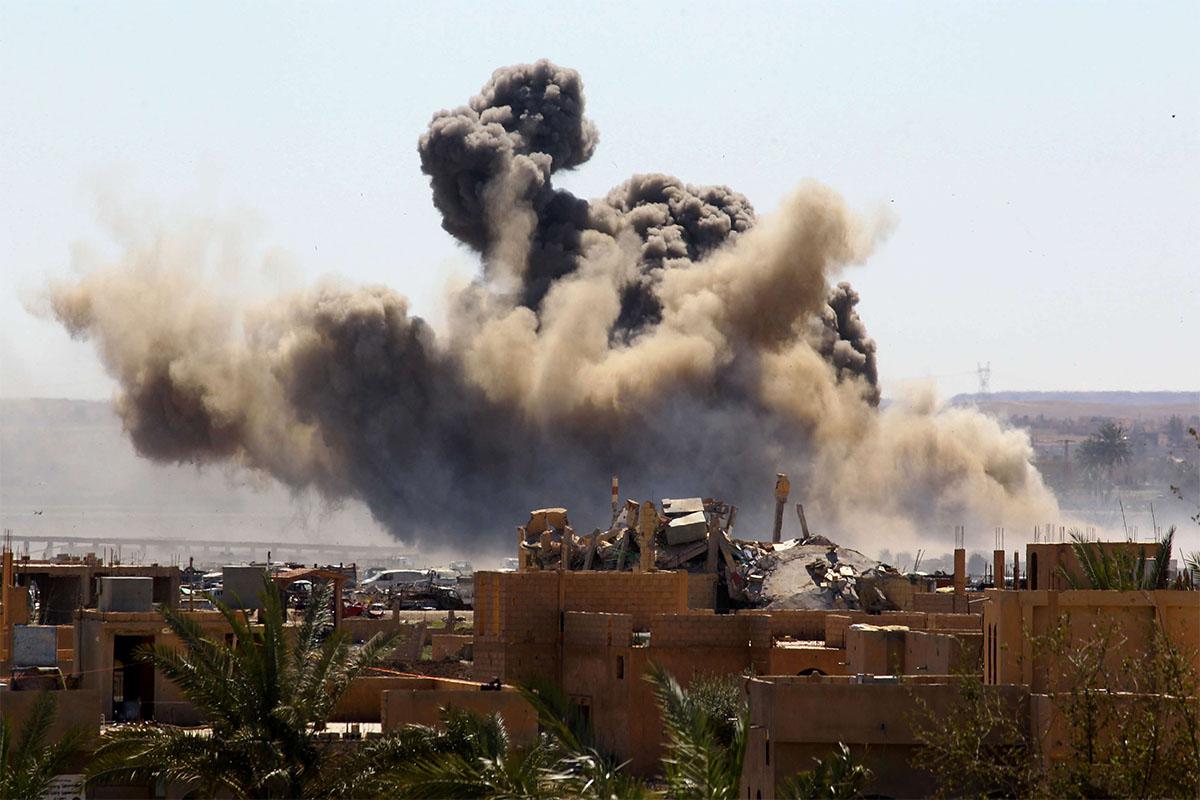 Smoke rises from the last besieged neighborhood in the village of Baghouz