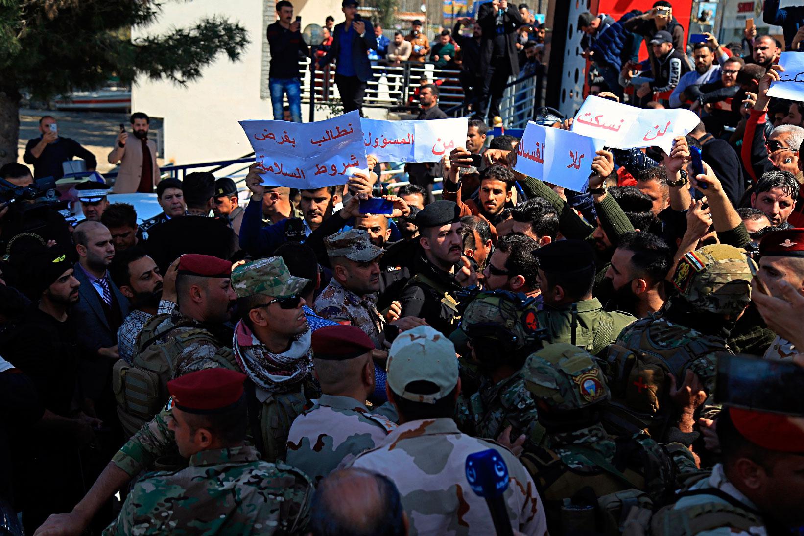 Angry relatives of victims the sunken ferry blocked a road where Iraq's presidential and Mosul's Governor convoy was passing, chanting "no to corruption" and pelting the provincial governor's car with stones in protest in Mosul, Iraq, Friday, March 22, 2019.