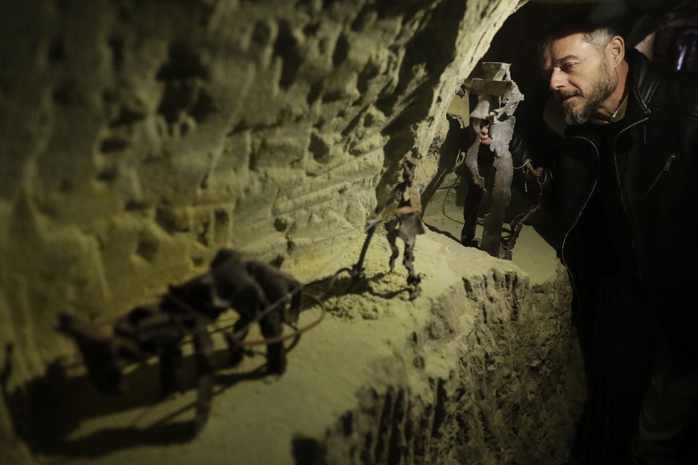 Lebanese Artist Charles Nassar inpsects of his sculptures made out of artilley shrapnels in the village of Remhala, South of Beirut.