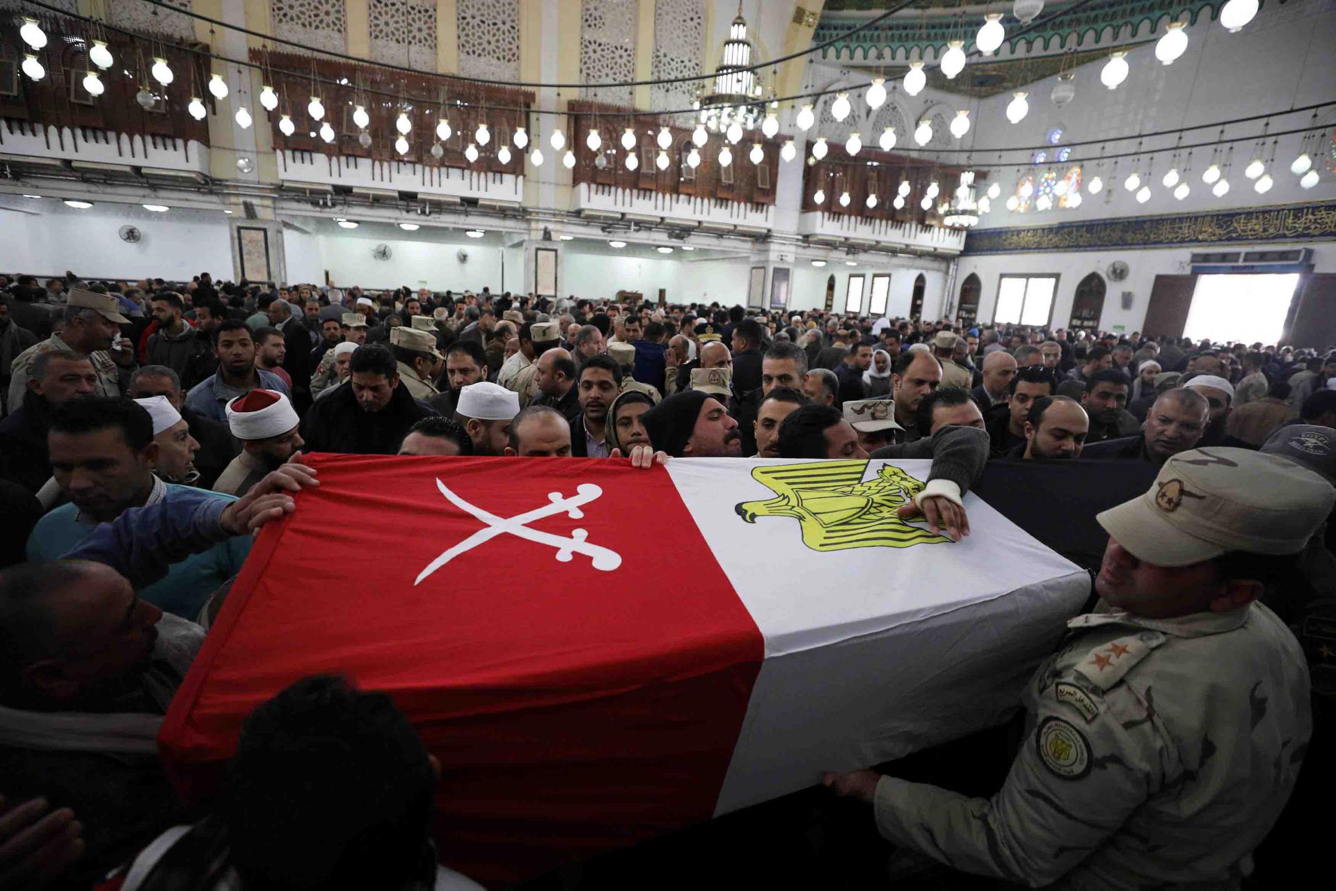 Mourners and members of security forces carry a coffin containing the body of Egyptian military officer Abdulrahman Ali Mohammed who was killed in a clash with militants in North Sinai