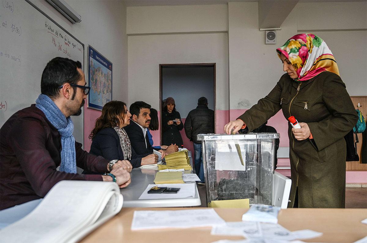 A woman casts her vote at a polling station in Istanbul 
