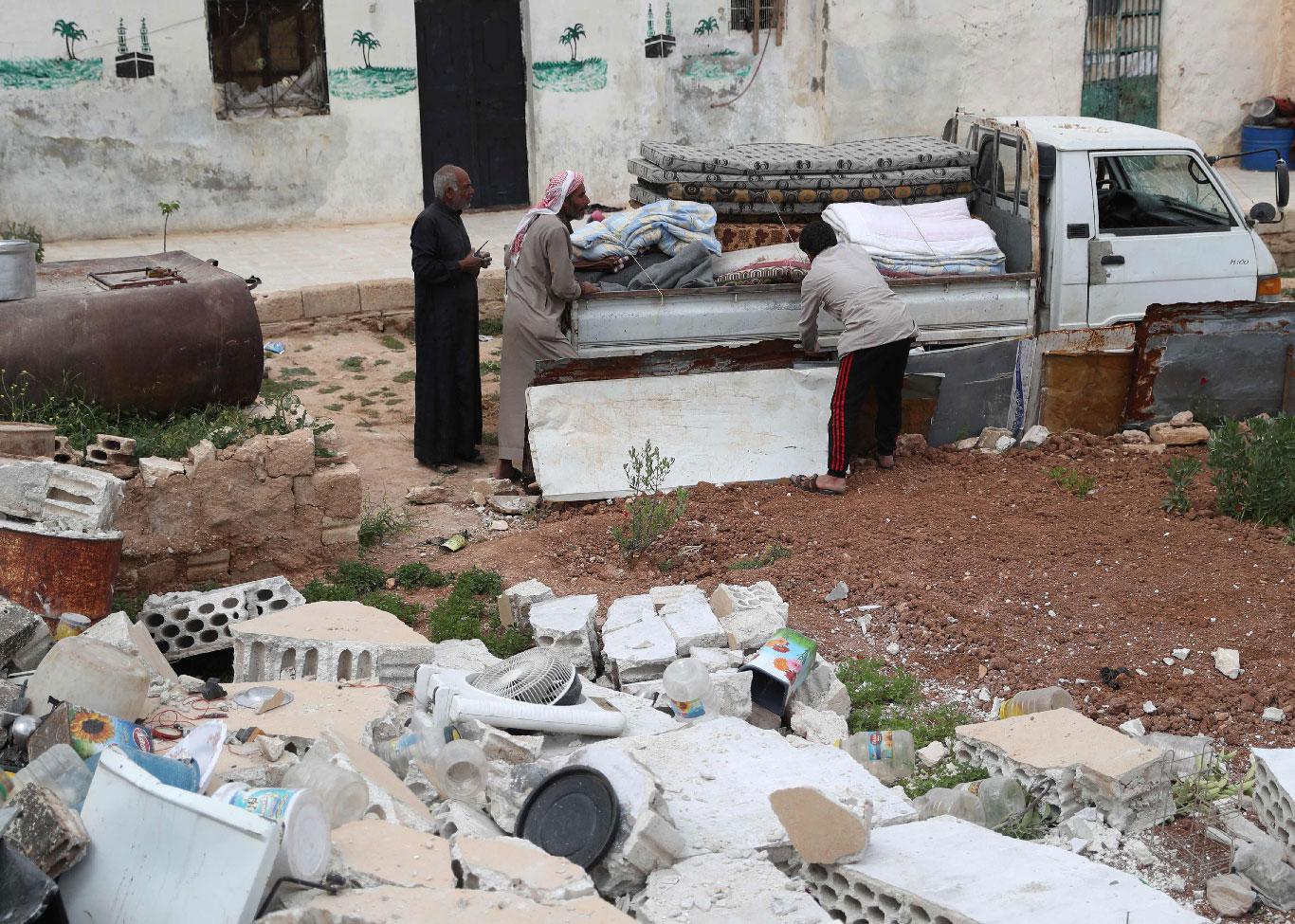 Syrians prepare to leave their houses in the village of Rabaa Jour