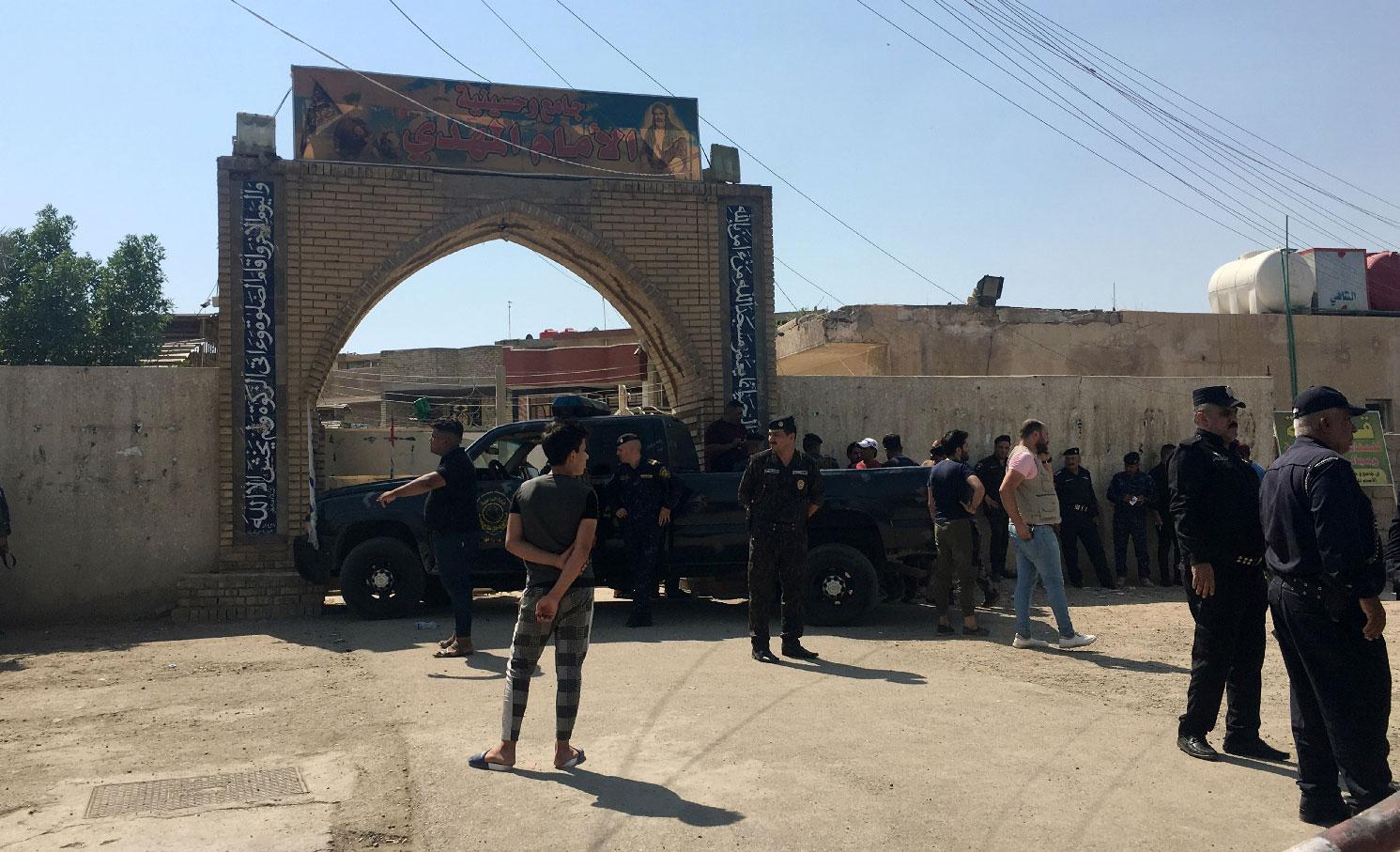 Iraqi security forces inspect the site of a bomb attack at a mosque in the Baladiyat neighbourhood of Baghdad