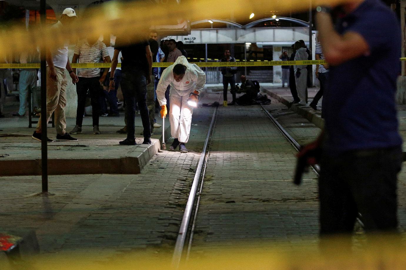 Authorities inspect the scene after a man reported to be wearing an explosive belt died in the Intilaka area in Tunis