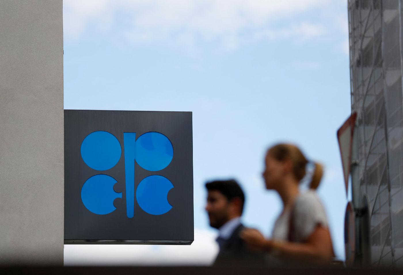 People walk outside the OPEC headquarters in Vienna