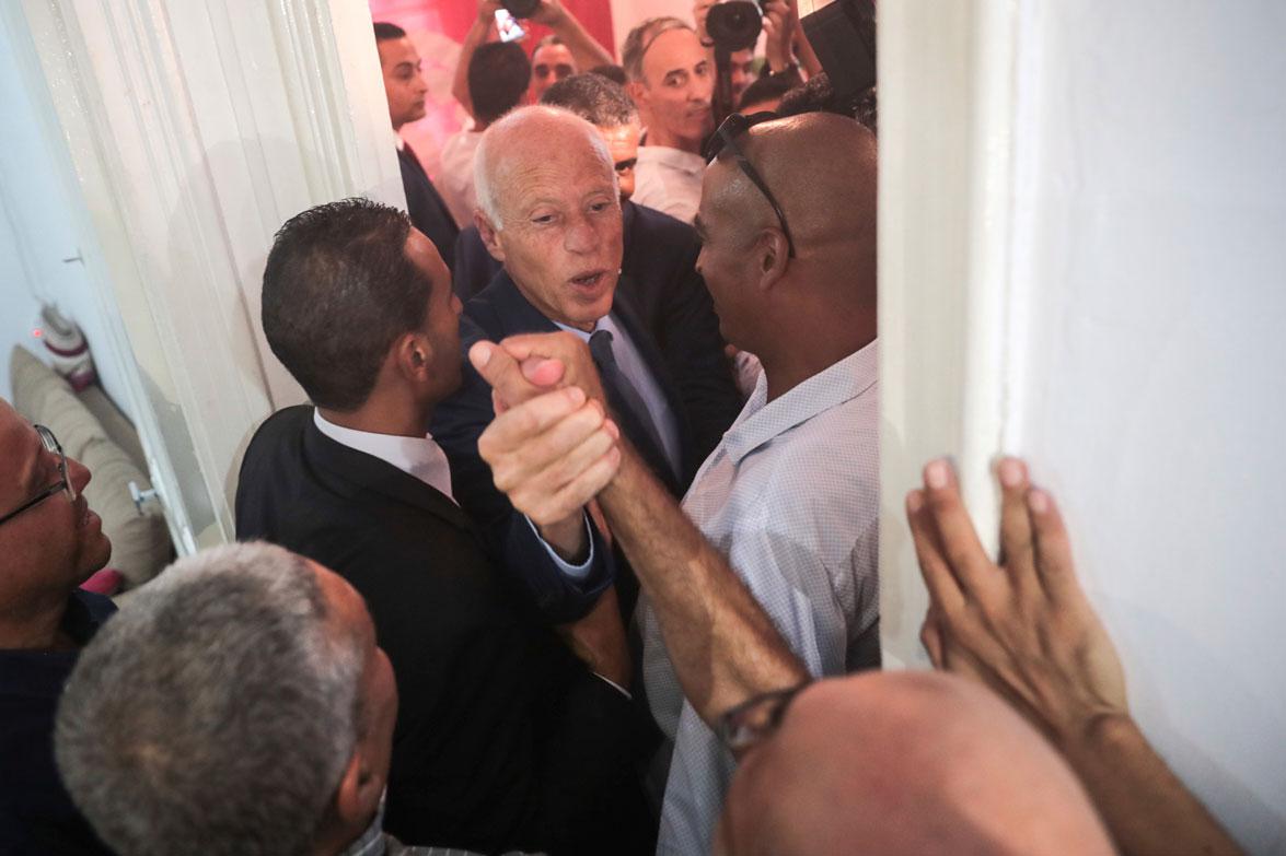 Tunisian independent law professor Kais Saied greets his supporters
