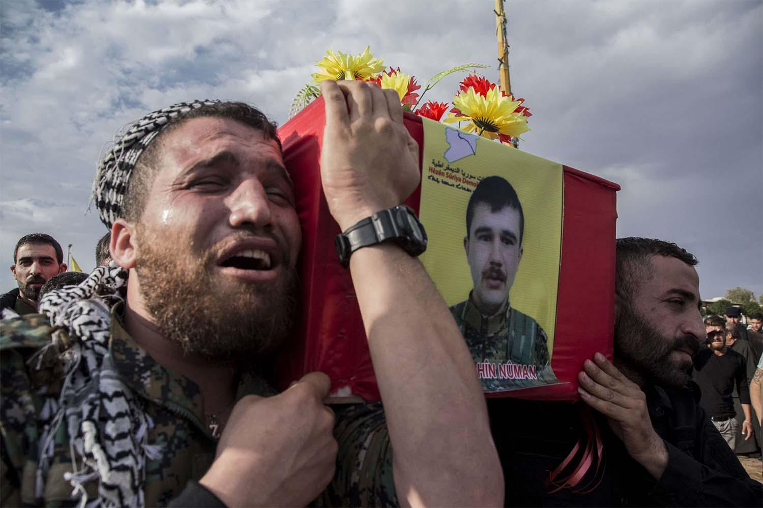 People attend funerls of Syrian Democratic Forces fighters killed recently fighting Turkish forces in the town of Hasakeh