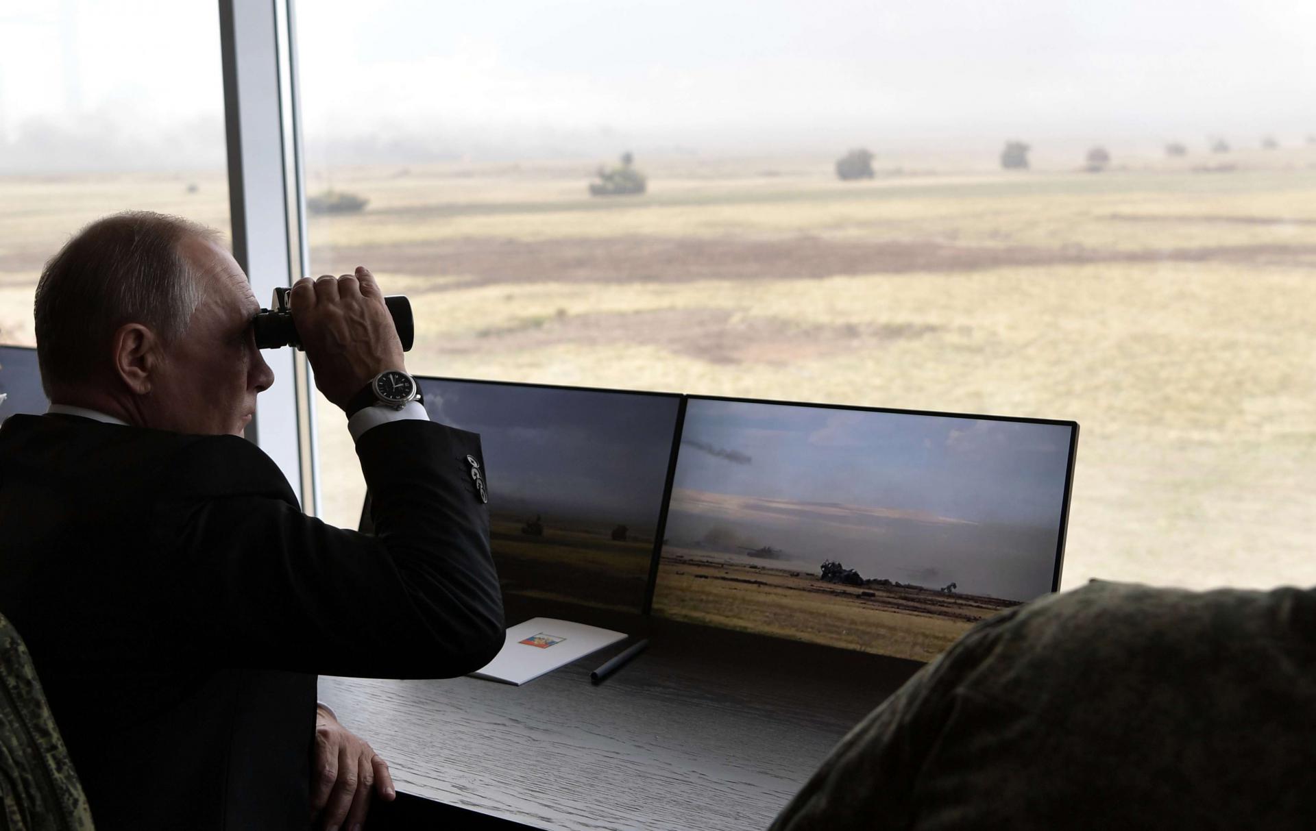 Photo taken on Friday, Sept. 20, 2019, Russian President Vladimir Putin holds binoculars while watching the military exercises Center-2019 at Donguz shooting range near Orenburg, Russia