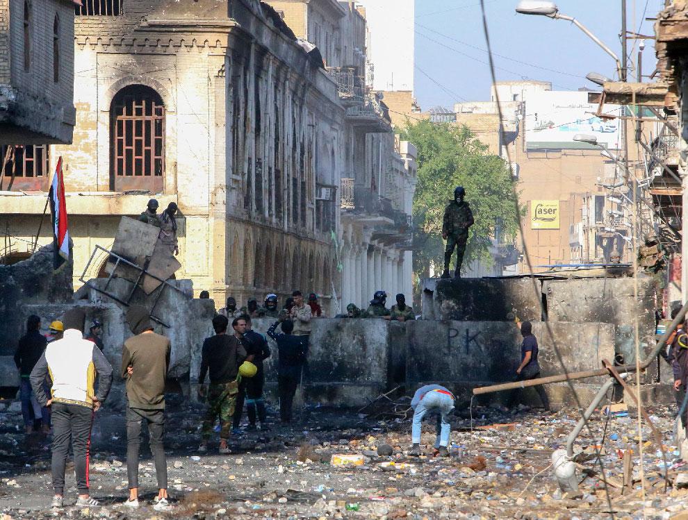 Iraqi demonstrators rally in Al-Rashid Street near the central bank in the capital Baghdad
