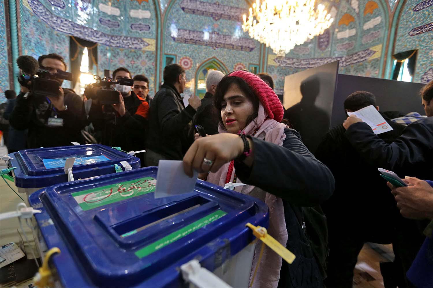iranian woman casts her ballot
