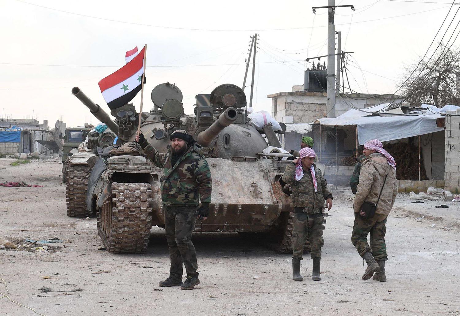 Syrian government forces deploy near the Damascus-Aleppo highway in the southern part of Syria's northern Aleppo province 