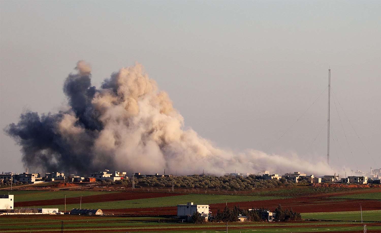 Smoke billows above the rebel-controlled village of Salihiyah near the regime-controlled town of Saraqeb