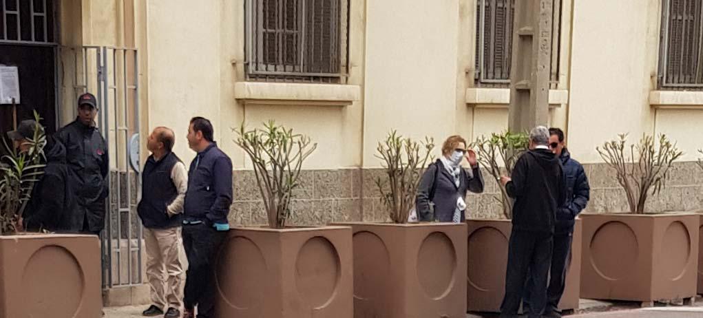 A woman wearing a protective mask outside the Italian school in Casablanca