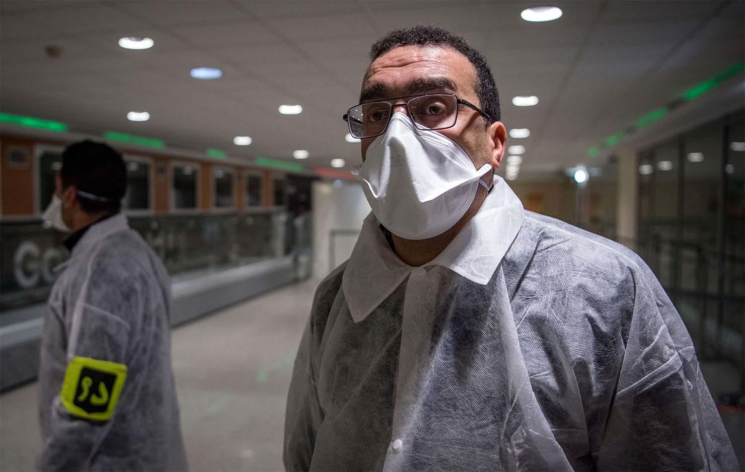 Moroccan health workers scan passengers arriving from Italy for coronavirus COVID-19 at Casablanca Mohammed V International Airport 