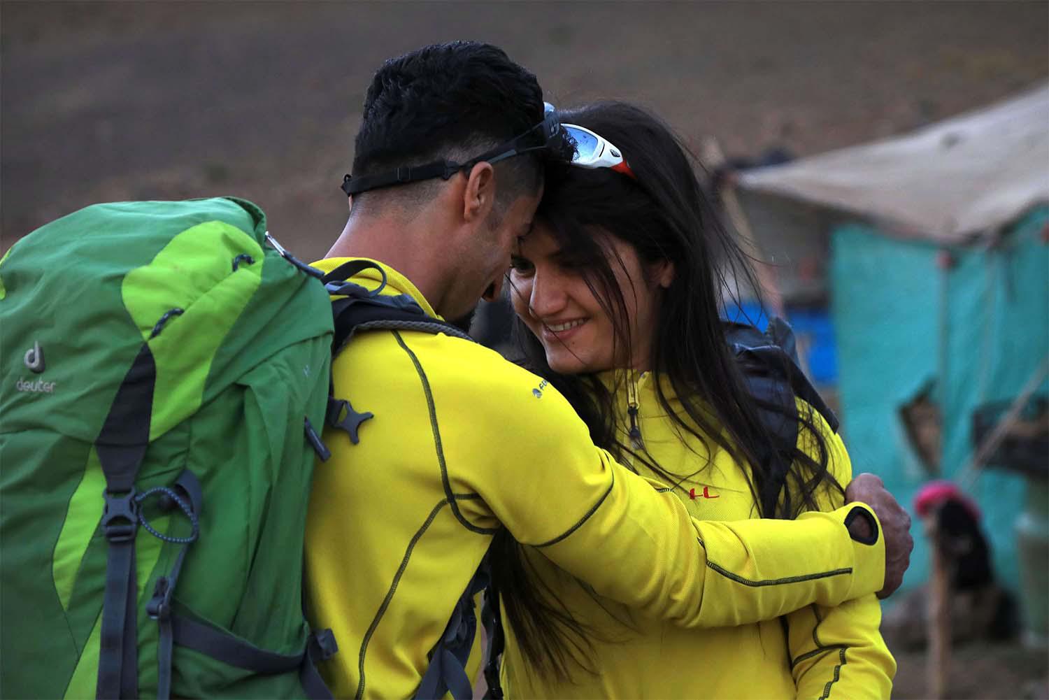 Newlyweds Iraqi Kurds Salar Chomany, 34, and Soma Mohammed, 28, walk together during a trekking ceremony at Mount Halgurd