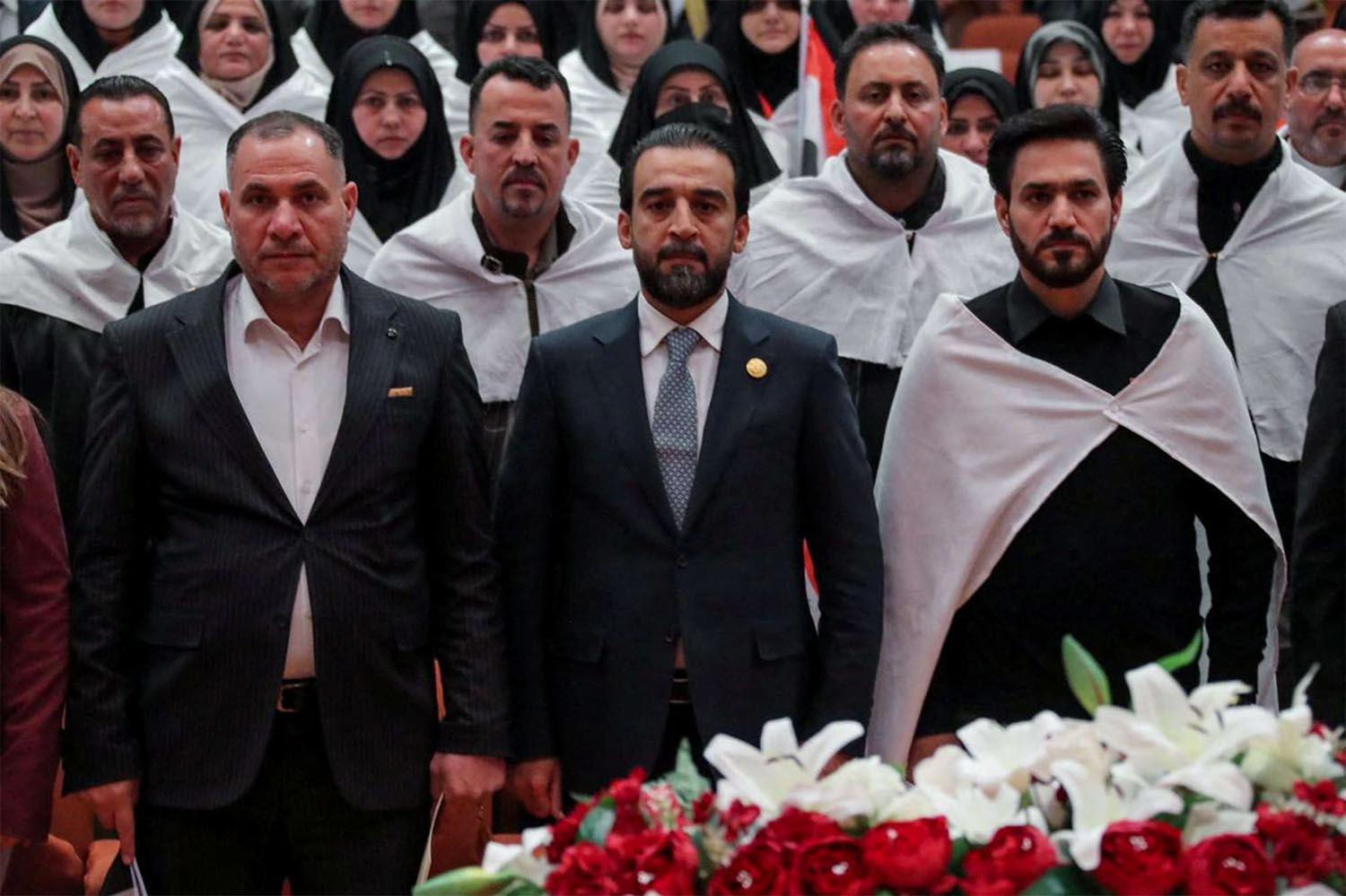 Iraq's newly elected for a second term as speaker of Parliament Mohammed al-Halbousi (C)