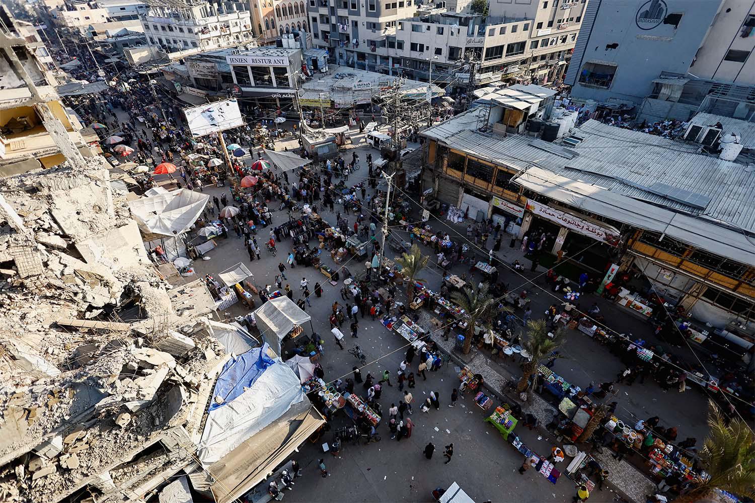 People gather and shop at a local market, in Nuseirat, central Gaza Strip