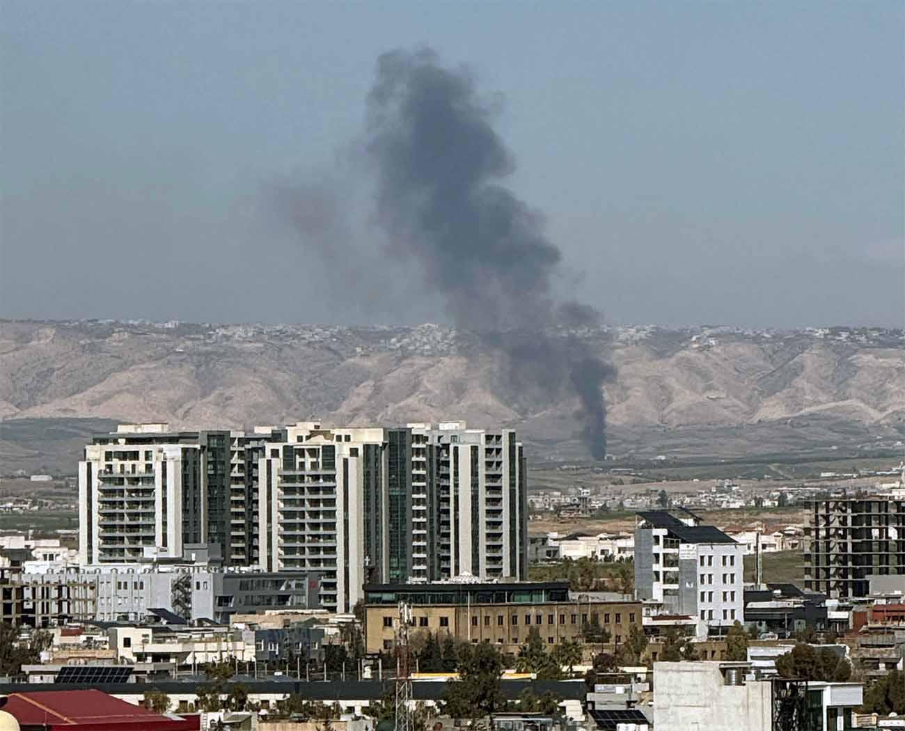 Smoke rises from the site of a drone crash on the outskirts of Erbil