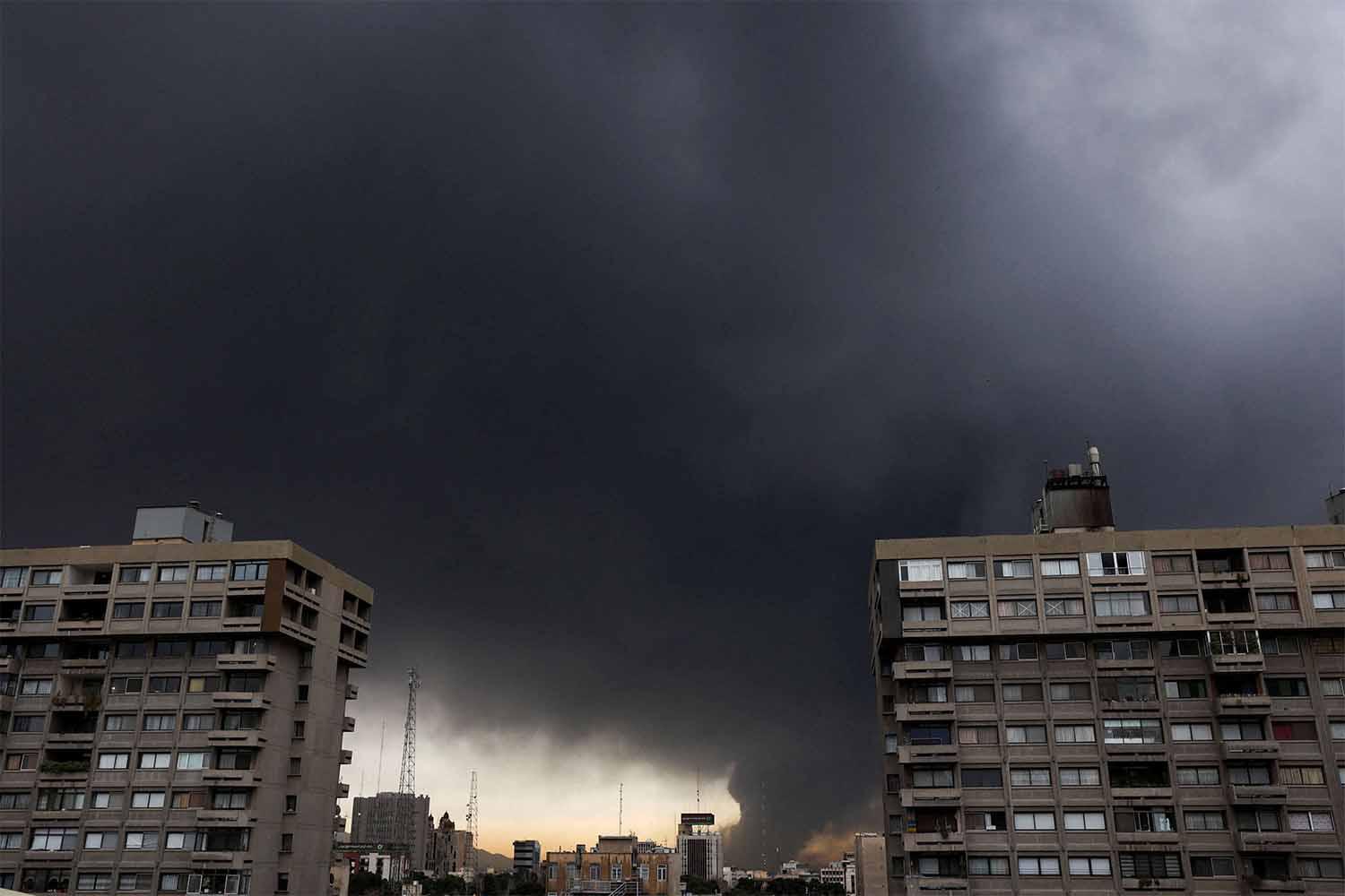 Smoke rises after a reported strike on fuel tanks at an oil refinery in Tehran