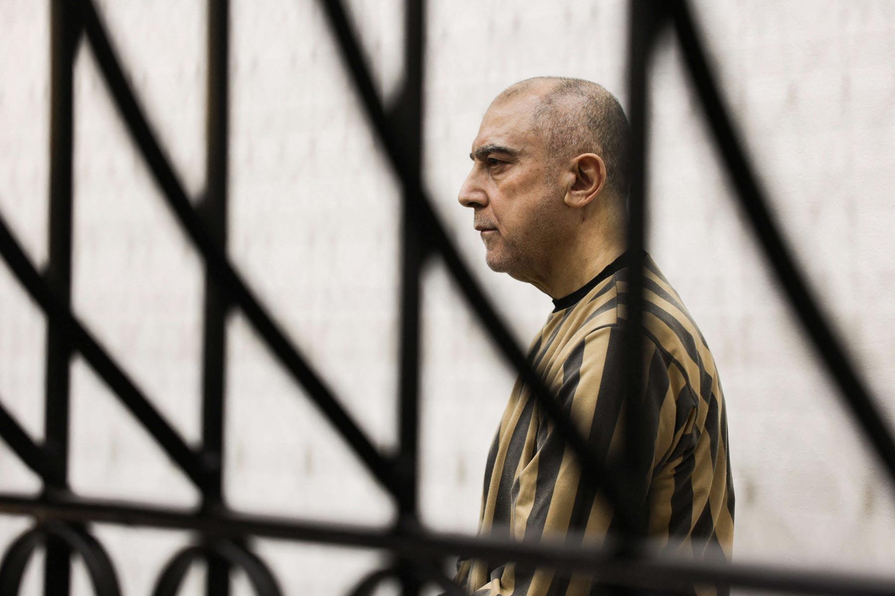 Atif Najib, a relative of Assad, appeared in court in handcuffs