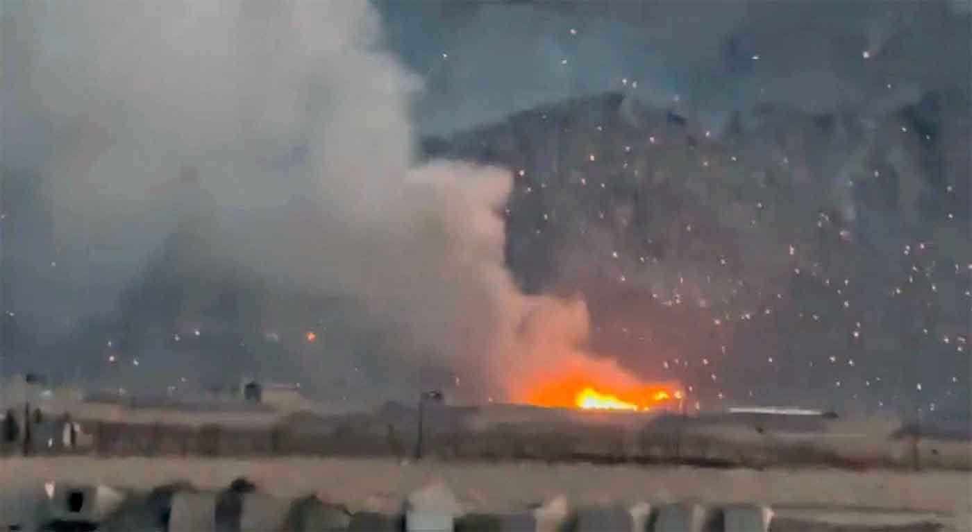 Burning debris litters the surrounding area, amid the US-Israeli conflict with Iran, in Baharestan, Isfahan province, Iran 