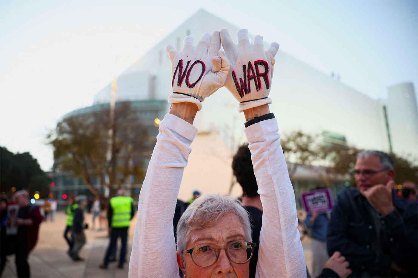 A demonstrator holds up her hands during an anti-war protest, calling for an end to the US-Israel conflict with Iran, in Tel Aviv,
